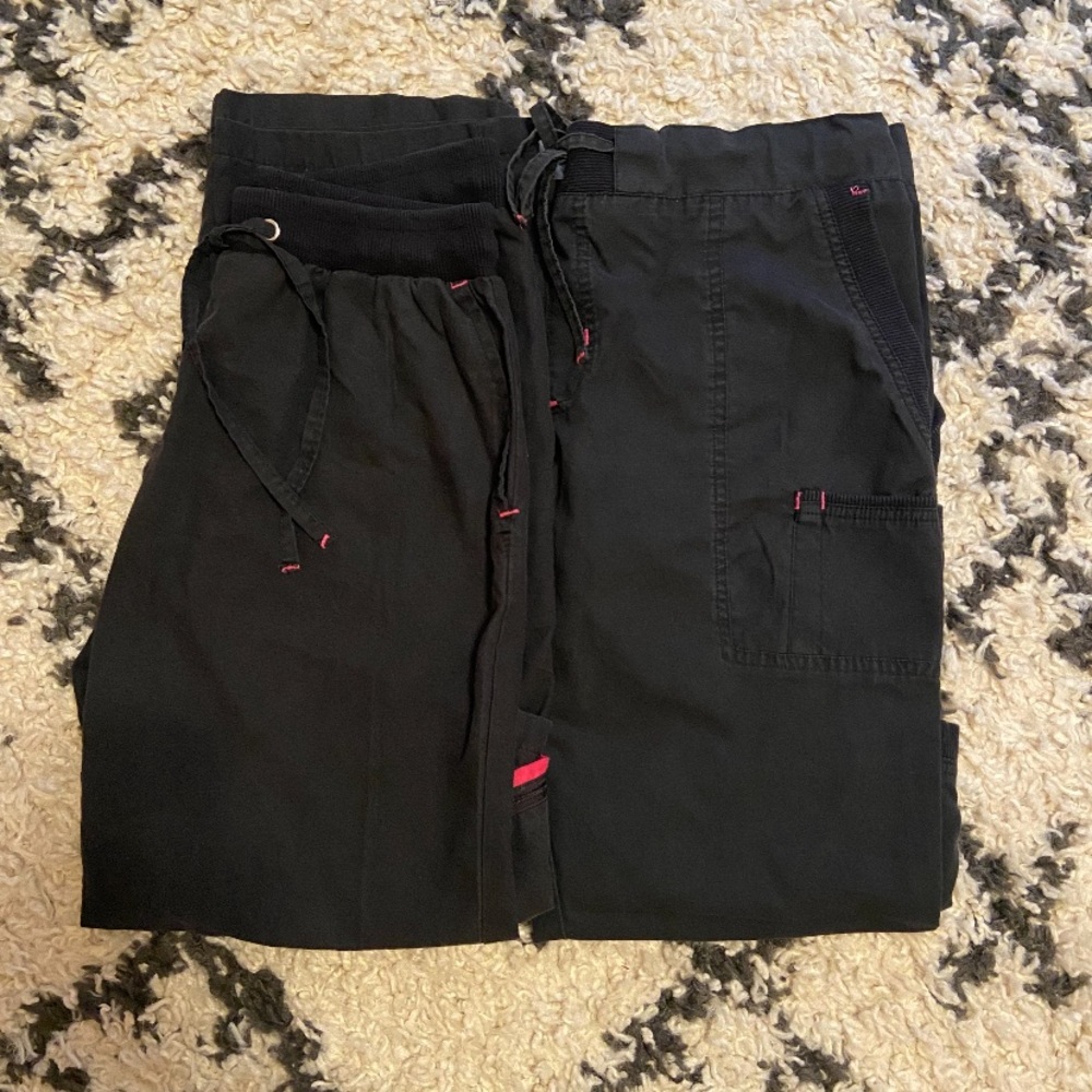 Two pairs of black and pink scrub pants!